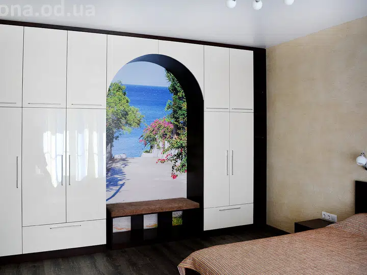 Bedroom with an arch to a guest room