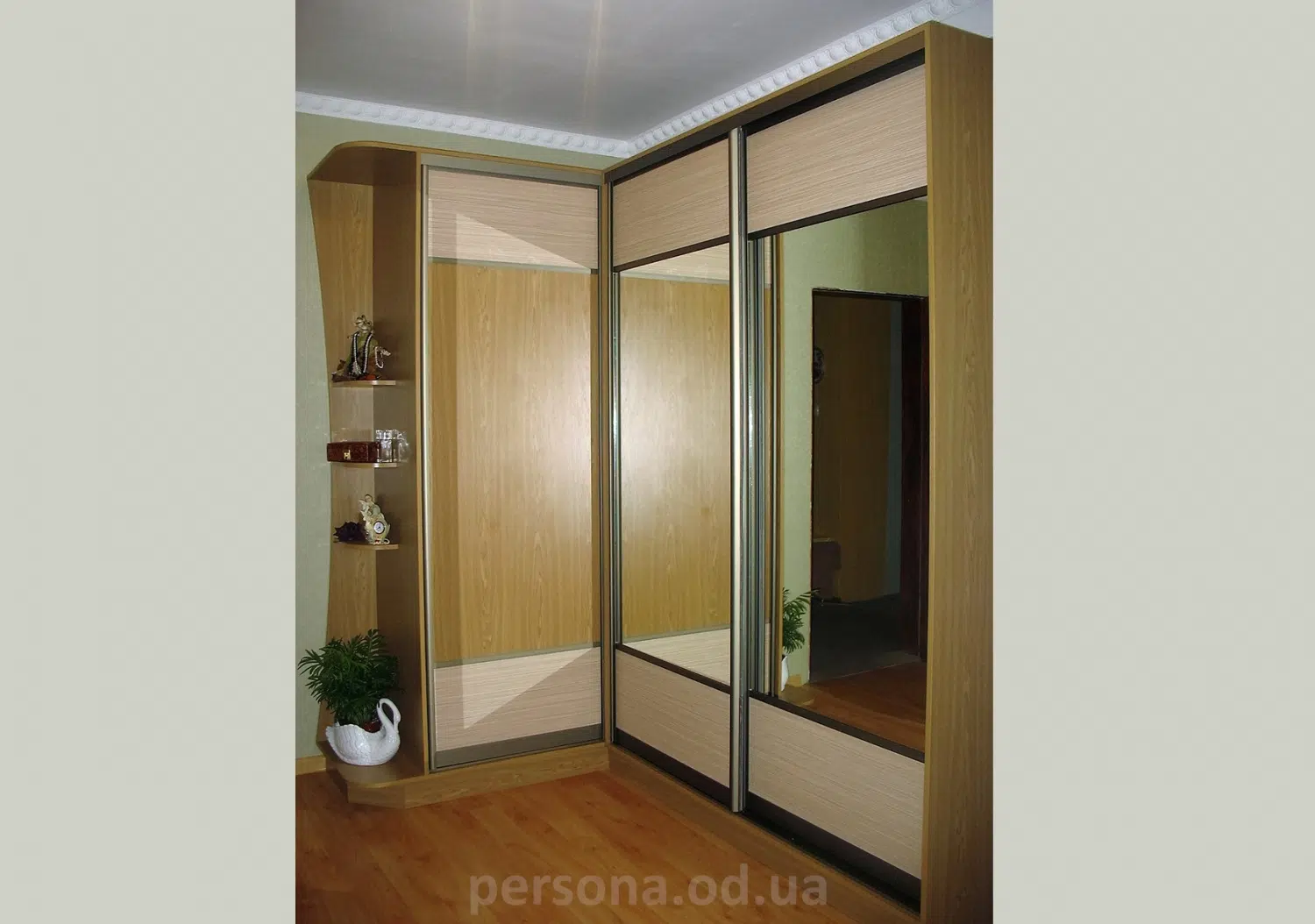 Corner wardrobe with a mirror in a hallway