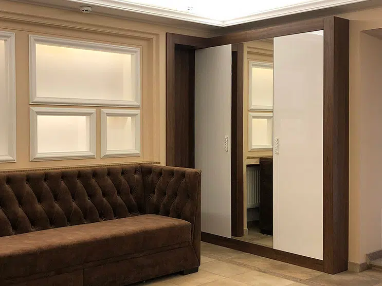Hinged-door wardrobe with a mirror in a living room