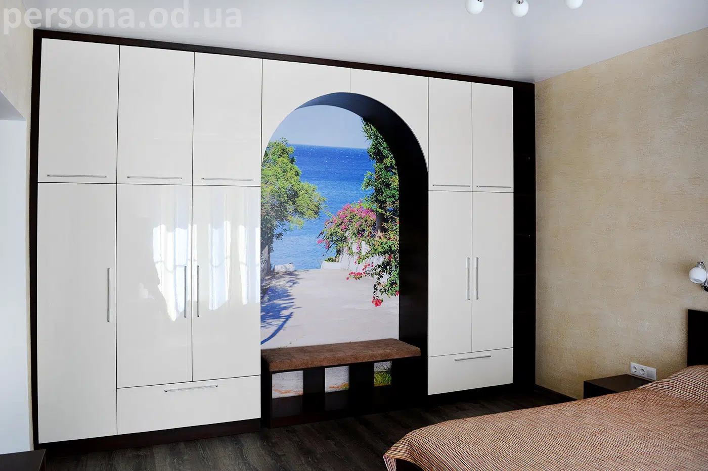 Bedroom with an arch to a guest room